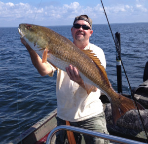Josh Guy with a bull redfish caught on some near shore bars. 