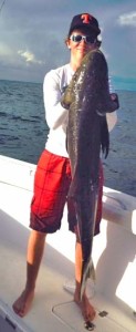 Jordan Hewitt with a cobia almost as tall as he is. 