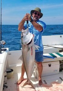 Rocky Motes with a huge amberjack.