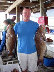 Frank Sheffield with a pair of excellent scamp grouper from a middle grounds trip. 
