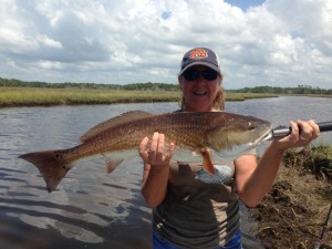 Sonya Reese nailed this 32 inch, 12 pound redfish in one of the local creeks fishing with her husband Kenny. 