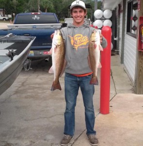 Brett Molzen with a nice pair of redfish; he had to release one to stay within his limit. 