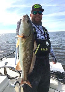 Capt. Grant Wilson with a fine upper-slot redfish. 