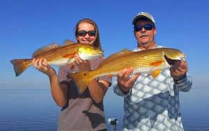 Jim and Morgan Carnes with a beautiful pair of schoolie redfish. 