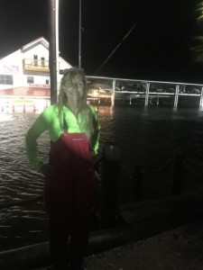 Boss Sea Hag Danielle Norwood standing across the street, showing the water level at the height of the storm surge. 